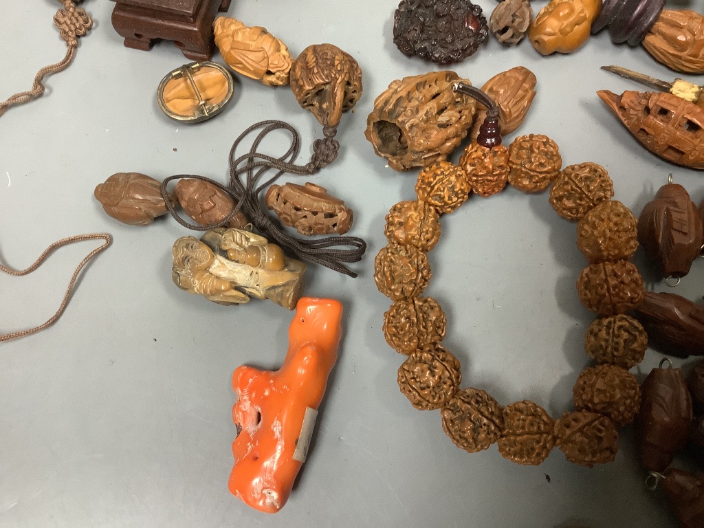 An assortment of Chinese peach stone and a nut carvings